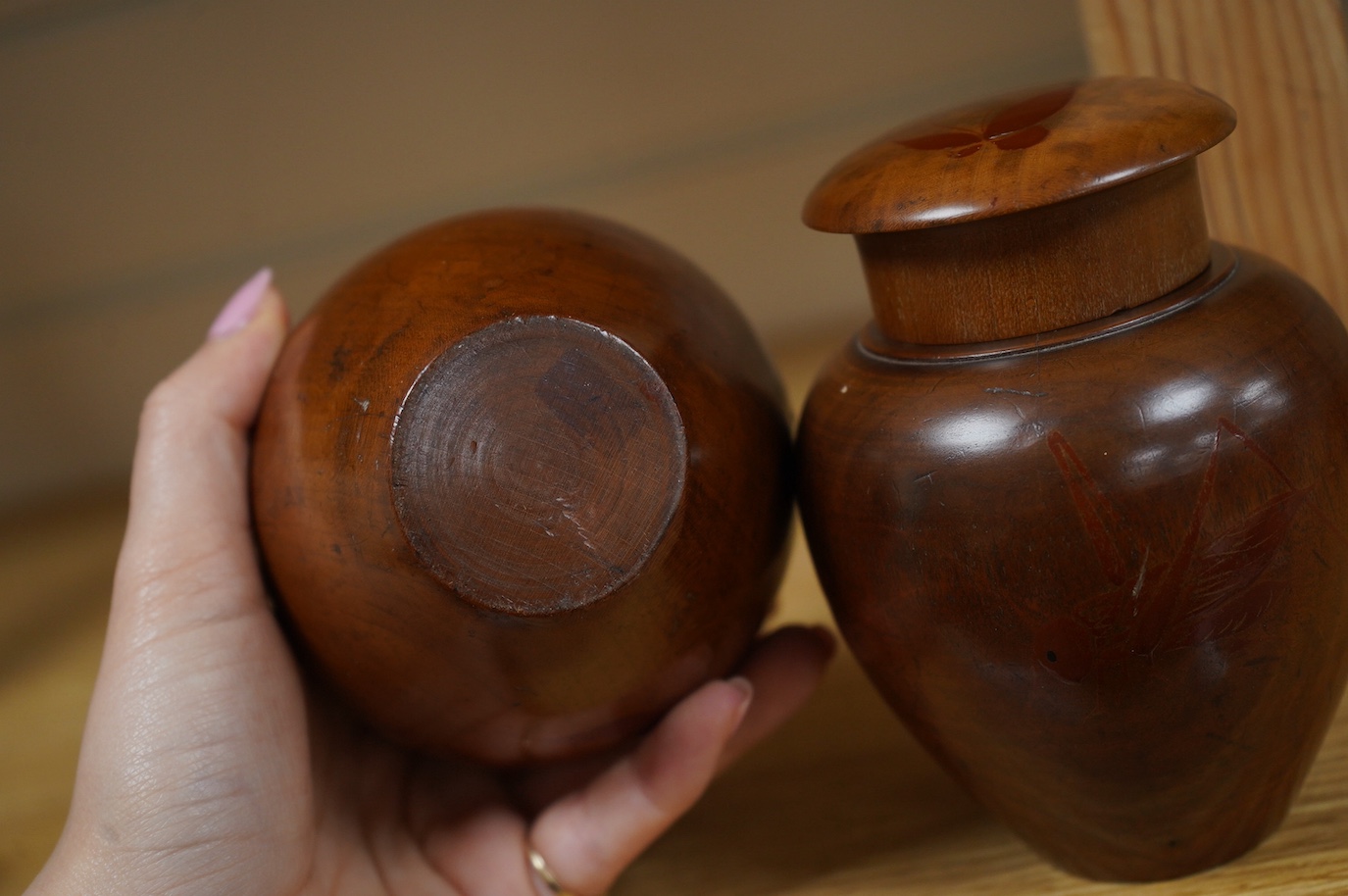 A pair of 18th century lacquered pear wood tea caddies, as seen in Pinto's book, page 293 and plate 315 (D), 12.5cm tall. Condition - repairs to covers, some wear to lacquer